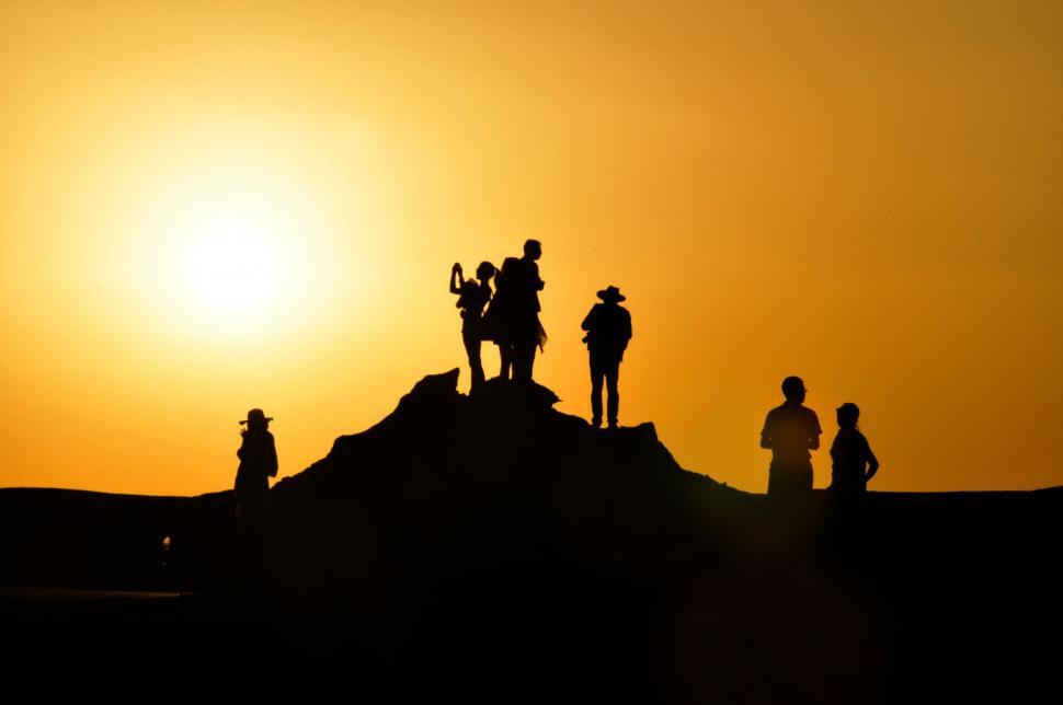 Free Image of Group of People Standing on Top of a Hill 