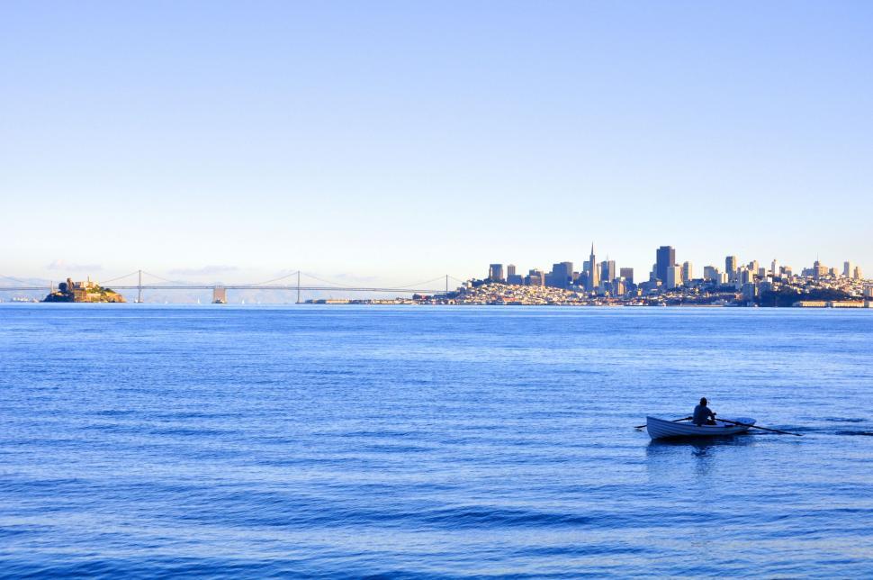 Free Image of Person Rowing Boat on Vast Lake 