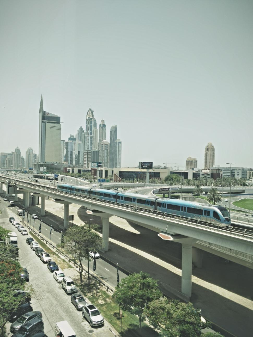 Free Image of Train Traveling Over Bridge Over Highway 