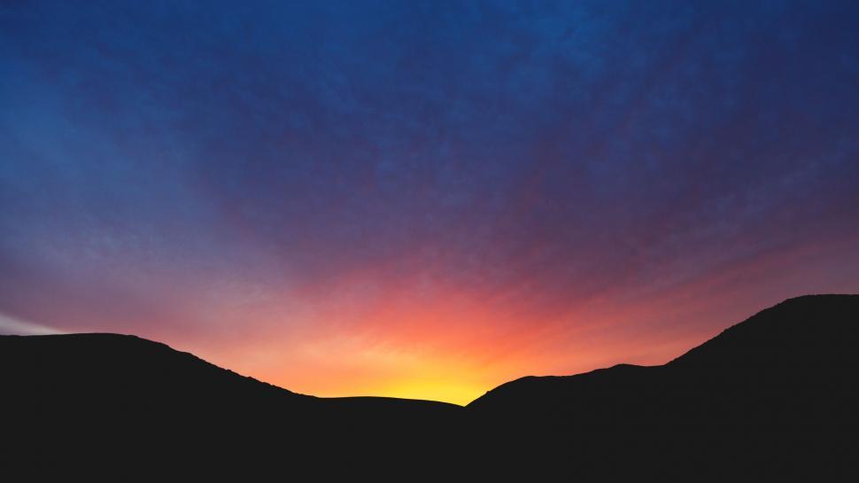 Free Image of Sun Setting Over Mountain Range 