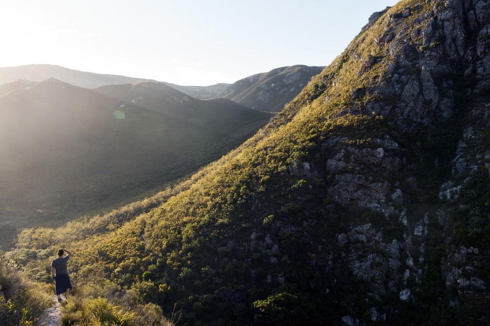 Free Image of Person Walking Up Trail in Mountains 