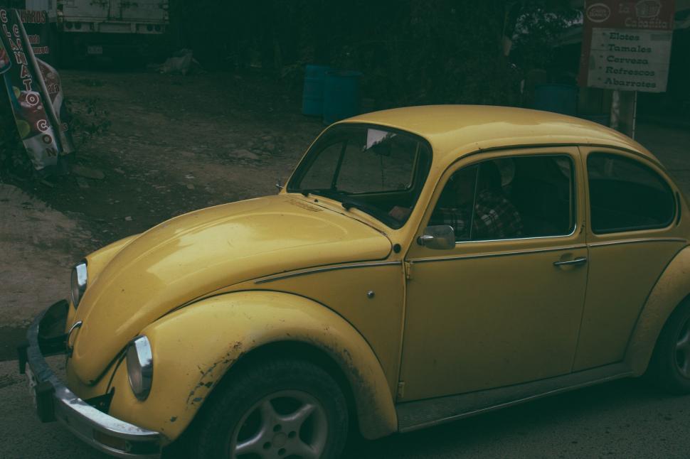 Free Image of Yellow Car Parked on Side of Road 