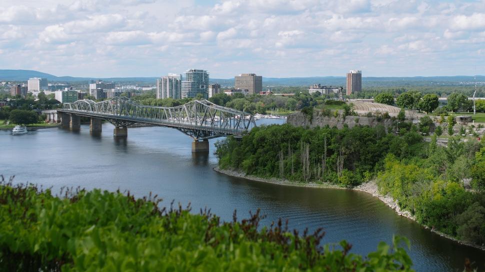 Free Image of Bridge Over River With City in Background 