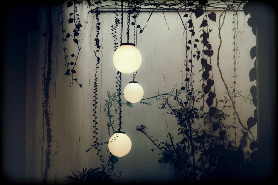 Free Image of Group of Lights Hanging From Ceiling Next to Window 