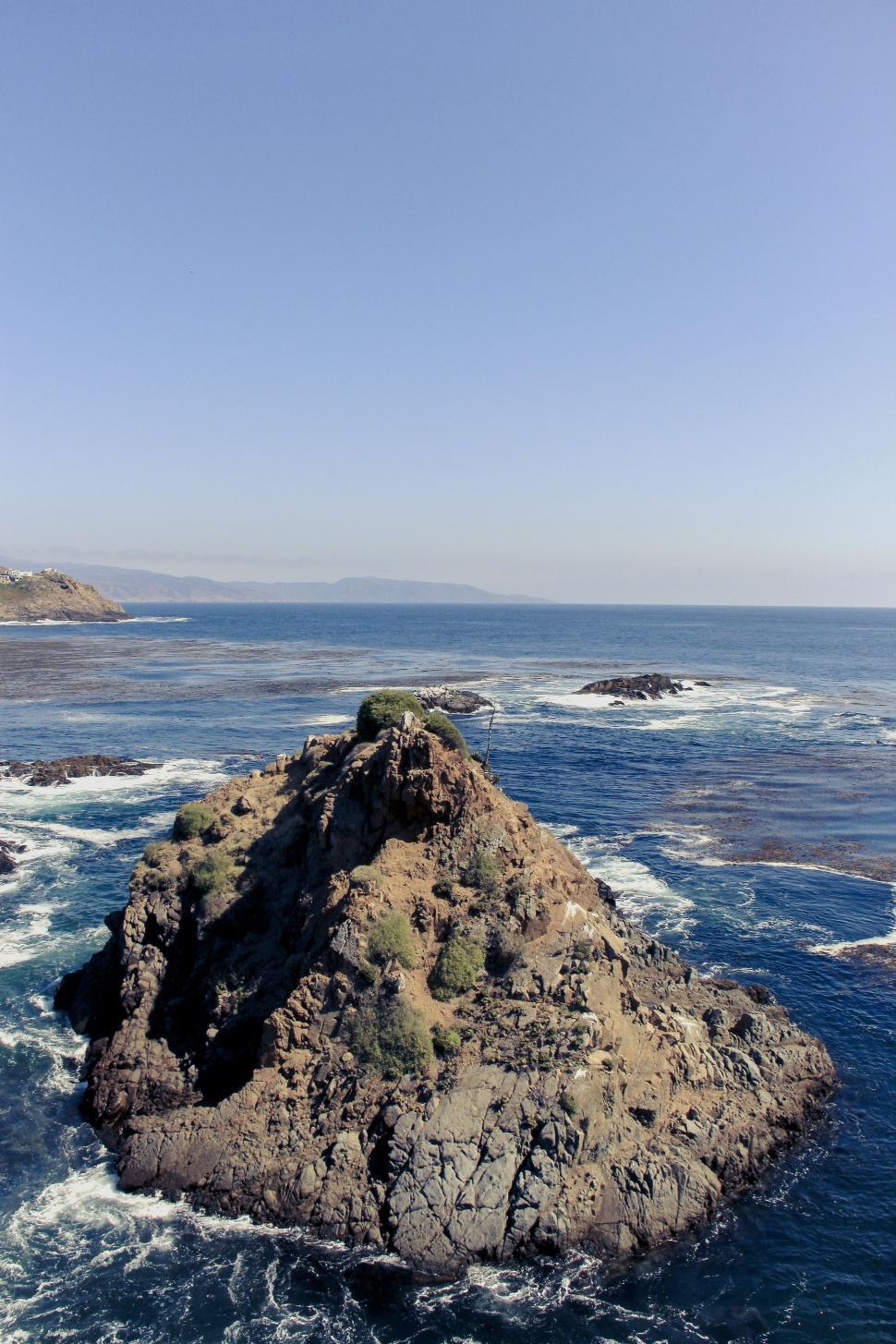 Free Image of Large Rock in Middle of Body of Water 