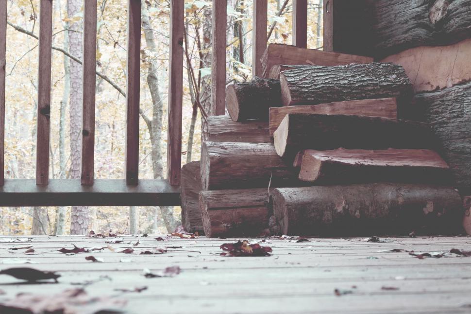Free Image of Stack of Logs on Wooden Floor 