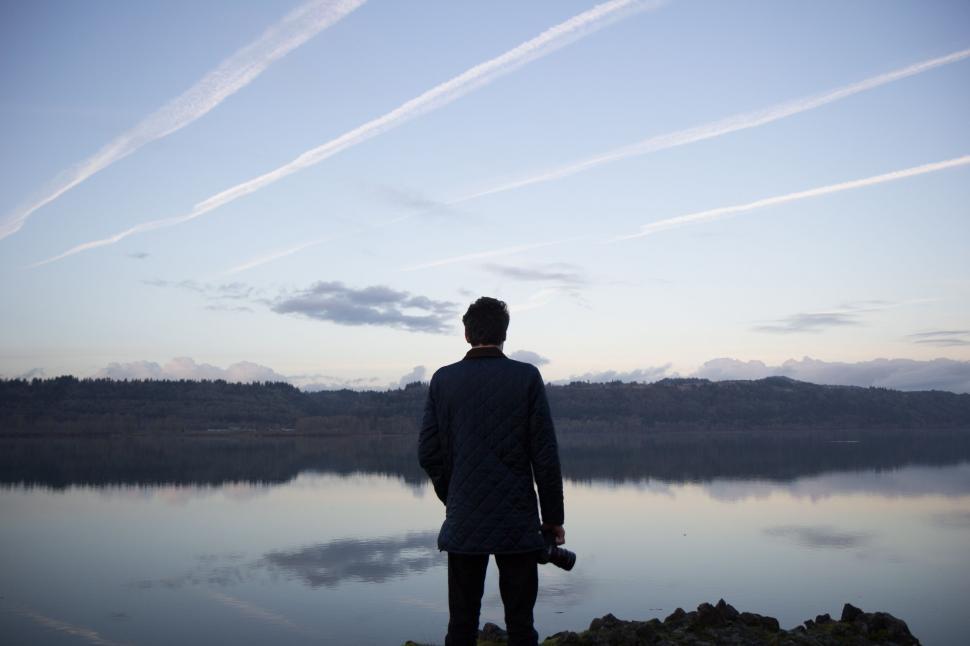 Free Image of Man Standing on Lake Shore 