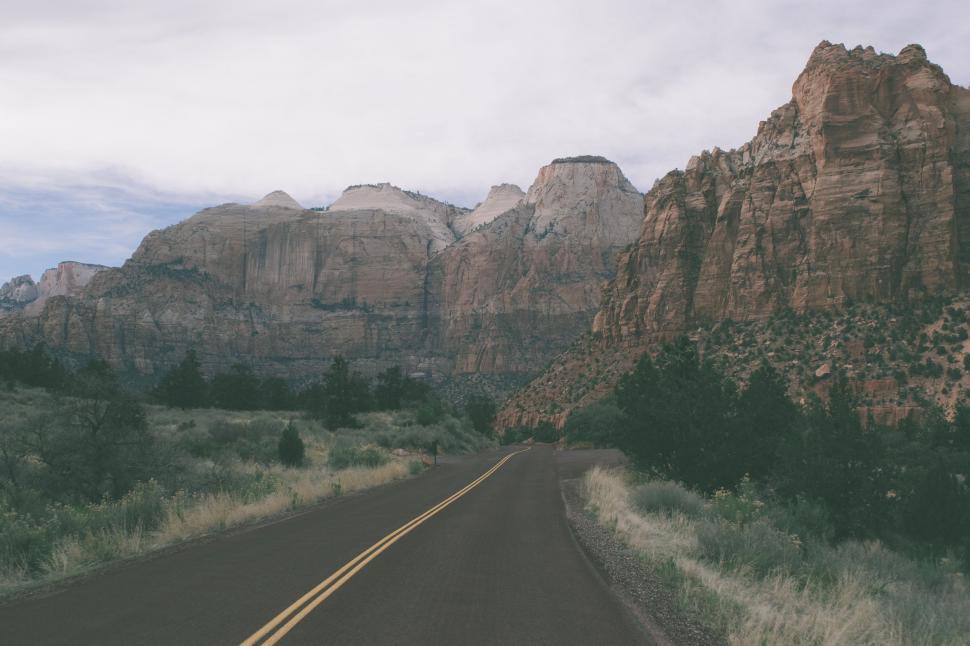 Free Image of Car Driving Along Mountain Road 