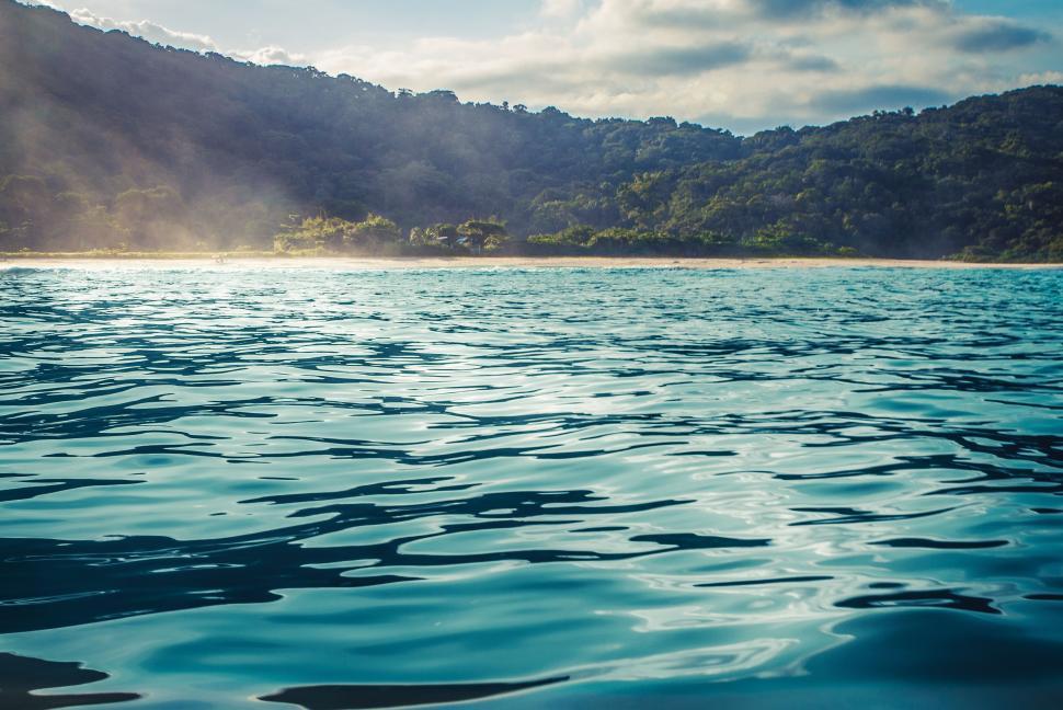 Free Image of Majestic Mountains Towering Over Pristine Body of Water 