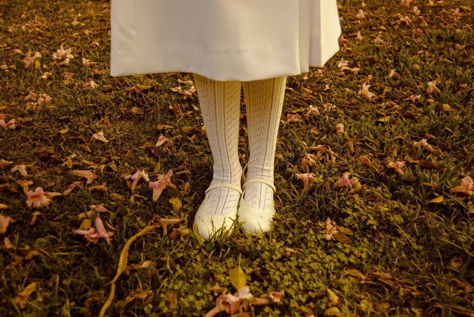 Free Image of Woman in White Dress Standing in Grass 