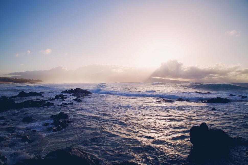 Free Image of Sun Shining Over Ocean and Rocks 