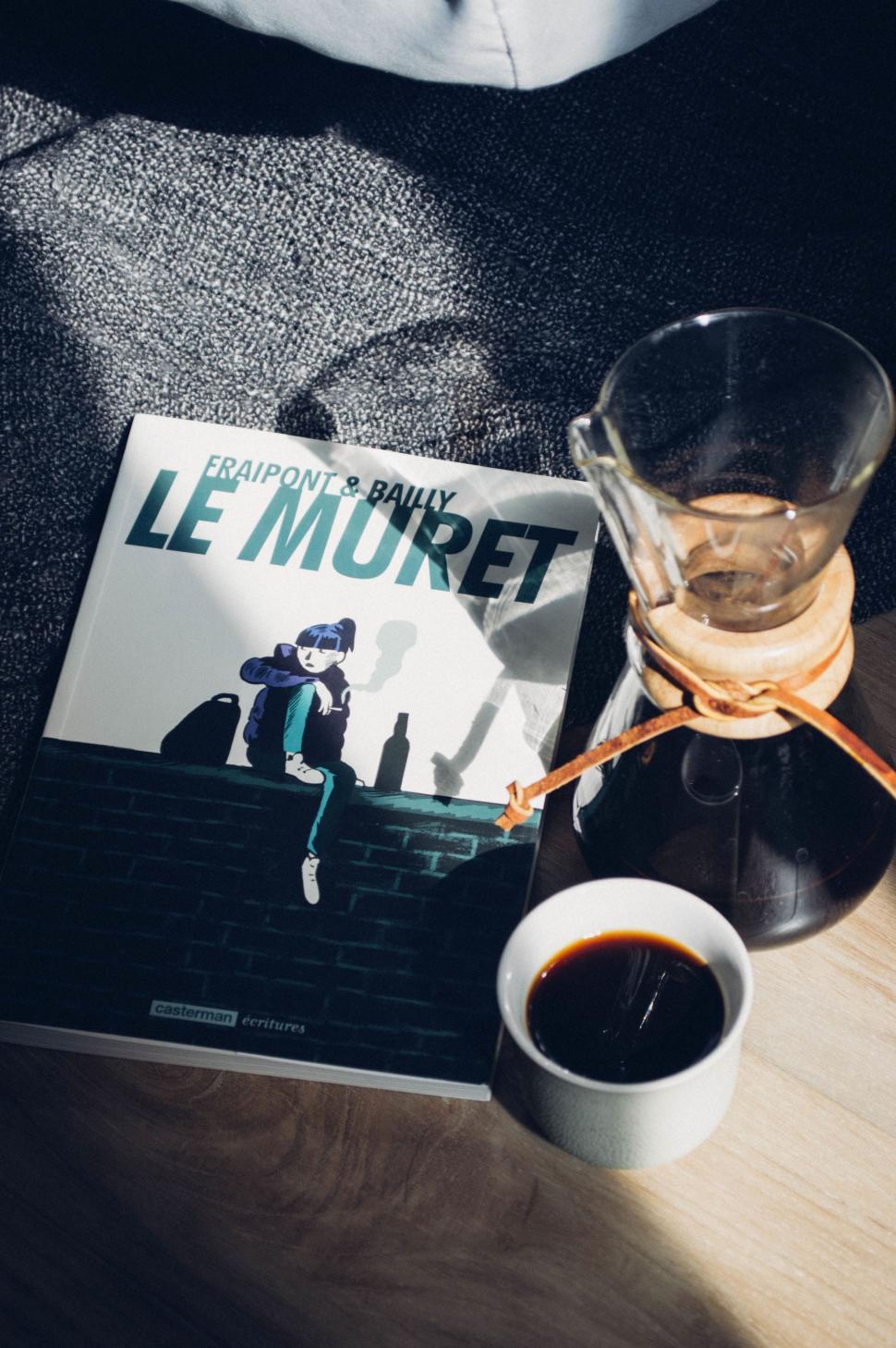 Free Image of Coffee Cup and Book on Table 