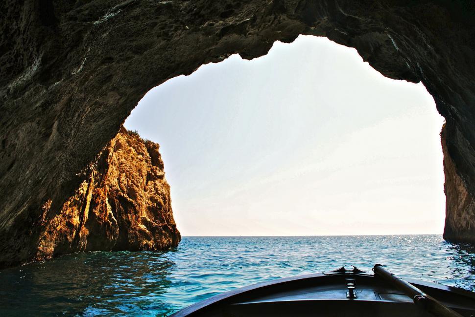 Free Image of Boat Sailing Near Rock Formation 