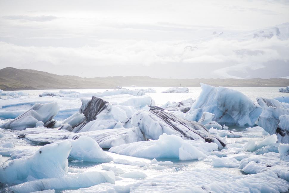 Free Image of Large Amount of Ice Floating on Top of a Body of Water 