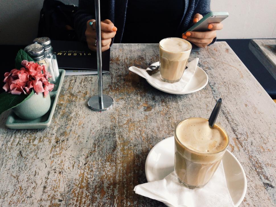 Free Image of Woman Sitting at Table With Two Cups of Coffee 
