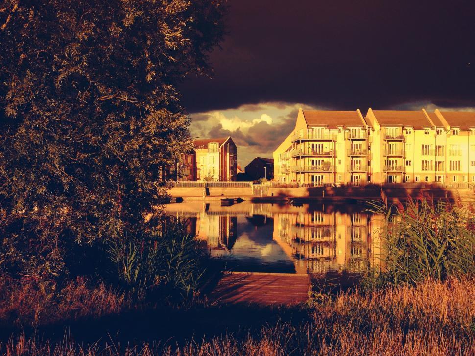 Free Image of Large Building Next to a Body of Water 