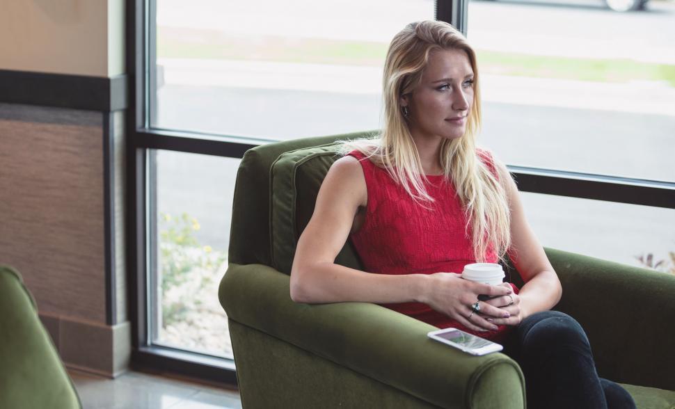 Free Image of Woman Sitting in Chair With Coffee 