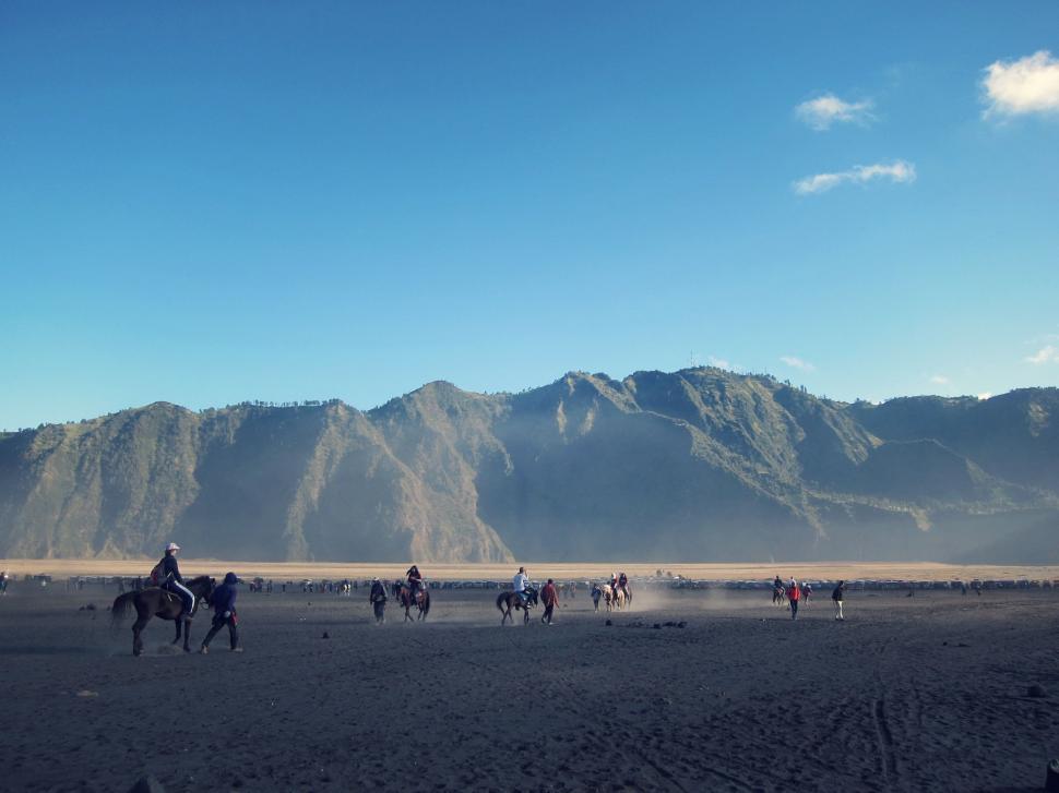 Free Image of Group of People Riding Horses Across Desert 
