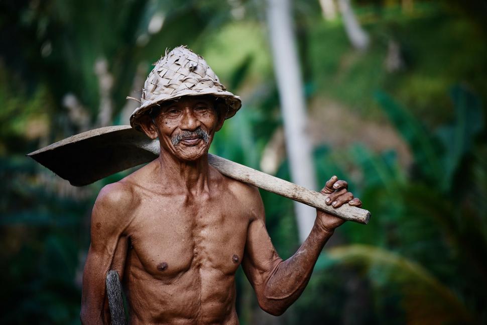 Free Image of Man Holding Large Wooden Stick 