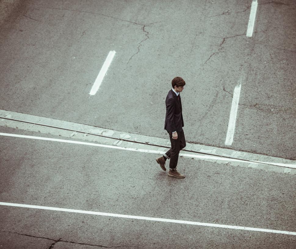 Free Image of Man Crossing Street Next to Crosswalk 