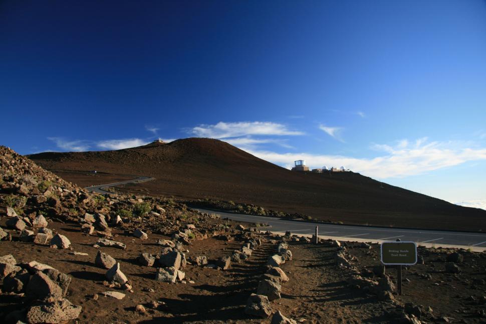 Free Image of Hill With Rocks and Street Sign 