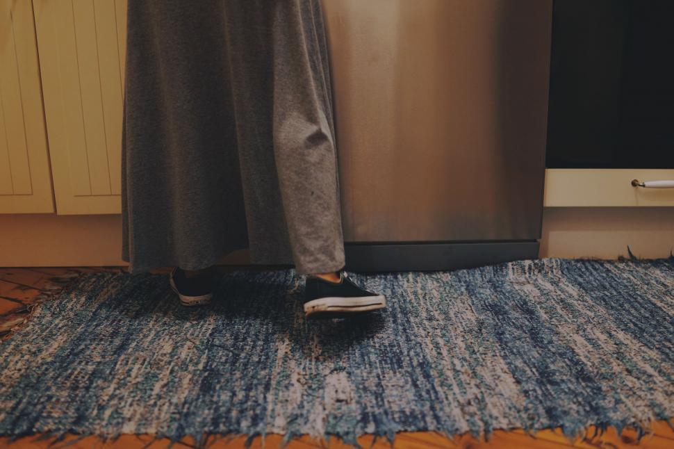 Free Image of Person Standing in Front of Dishwasher 