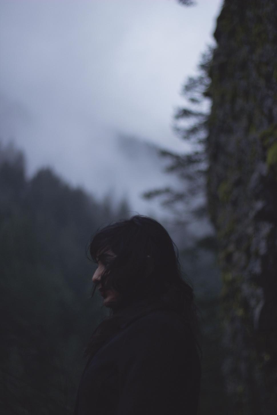 Free Image of Man Standing Beside Tall Tree 