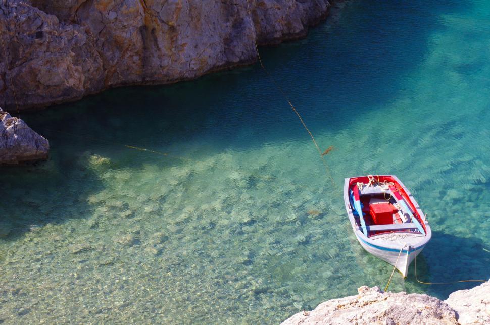 Free Image of Small Boat Floating on Body of Water 