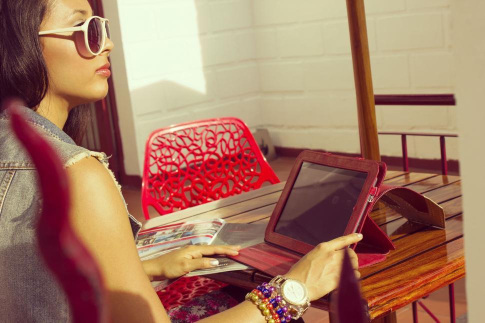 Free Image of Woman Sitting at Table Using Laptop Computer 
