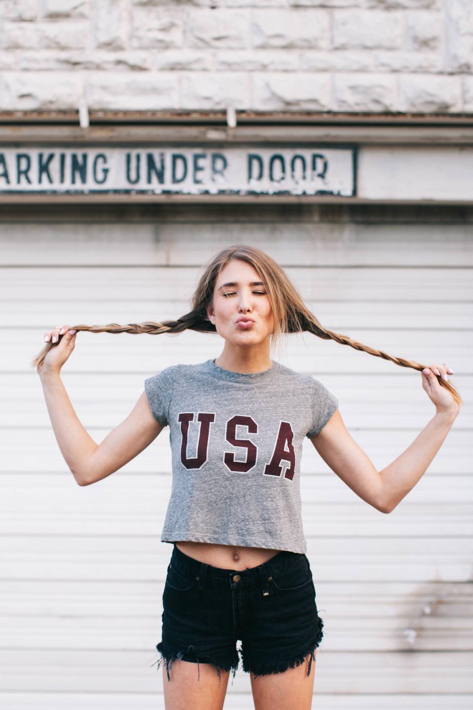 Free Image of Woman Holding Rope in Front of Building 