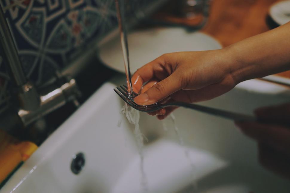Free Image of Person Cutting Glass With Scissors 