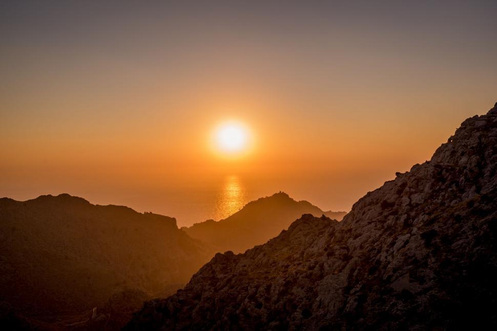 Free Image of Sun Setting Over Mountain Range 