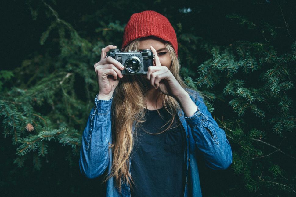Free Image of Woman Taking a Picture With a Camera 