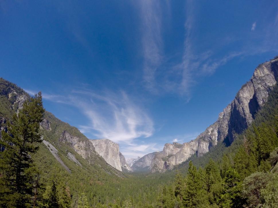 Free Image of Majestic Mountain Range With Trees in Foreground 
