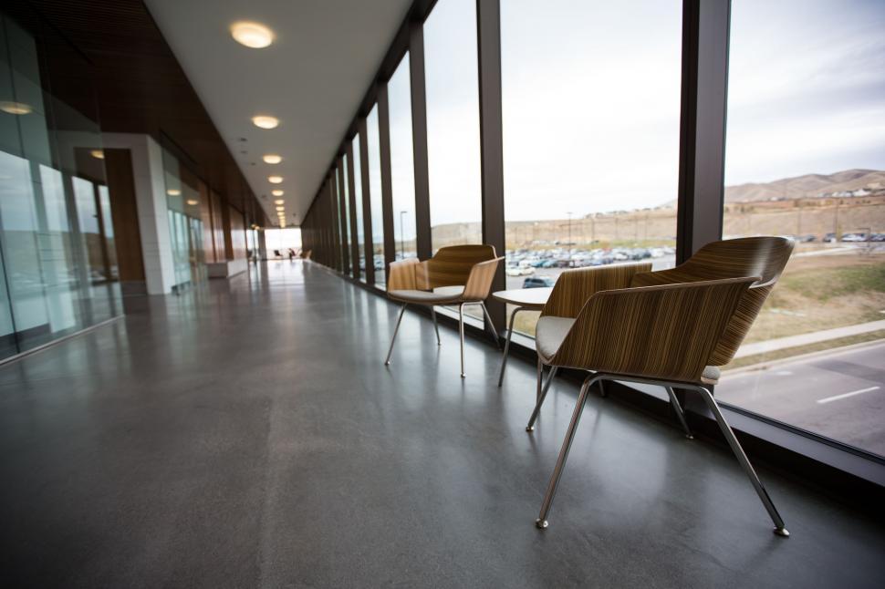 Free Image of Row of Chairs Next to Large Window 
