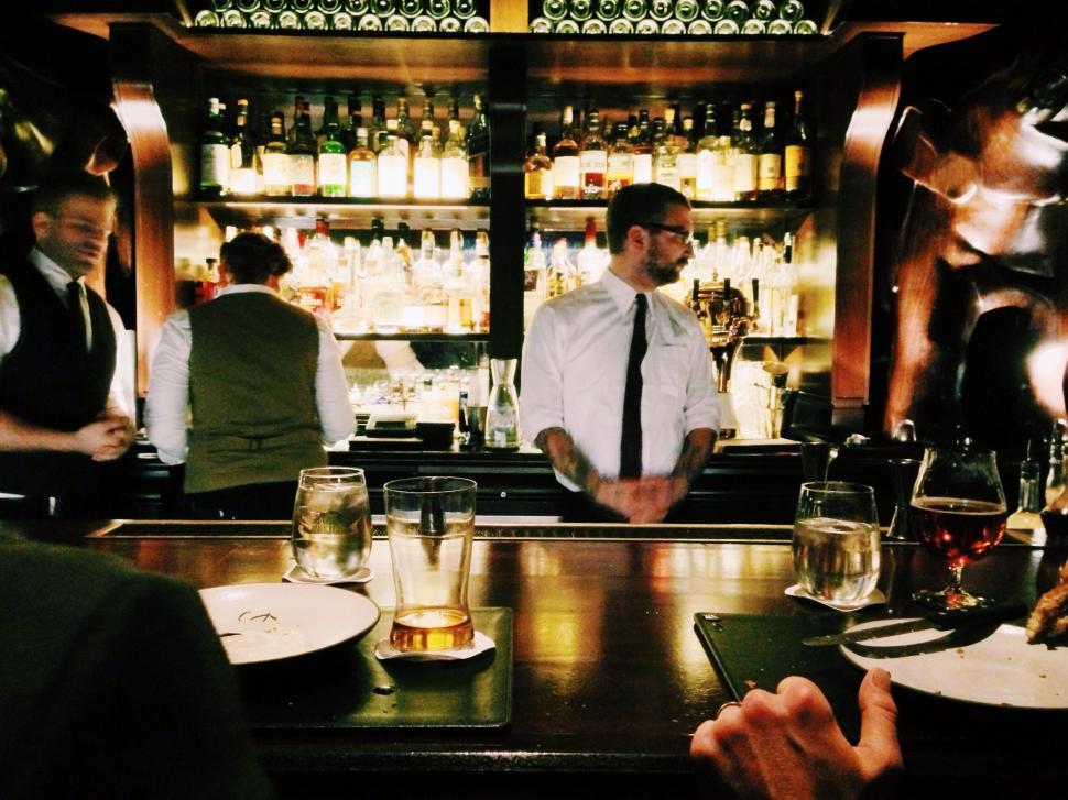 Free Image of Group of People Sitting at a Bar 