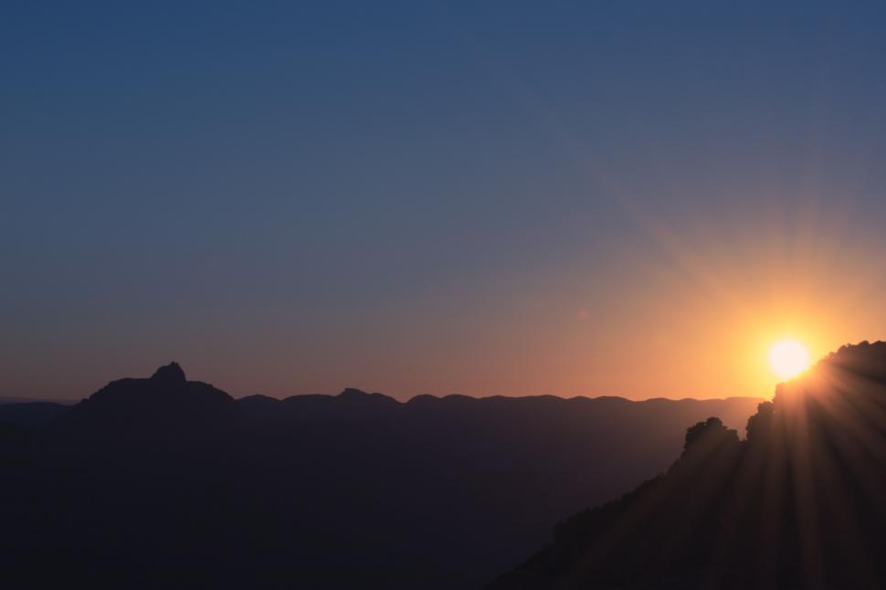 Free Image of Sun Setting Over Mountain Range 
