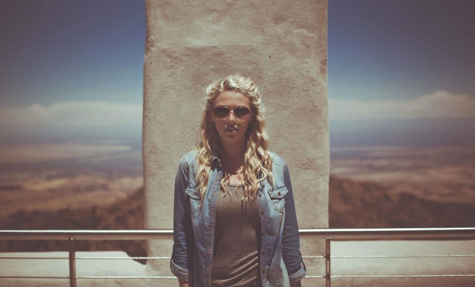 Free Image of Woman Standing in Front of Tall Building 