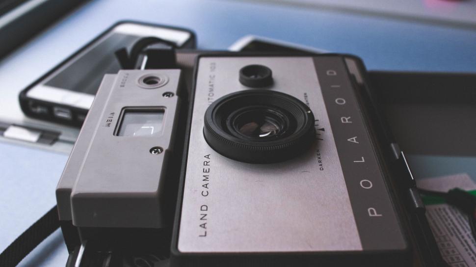 Free Image of Camera and Cell Phone on Table 