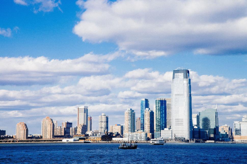 Free Image of City Skyline Overlooking Vast Water 