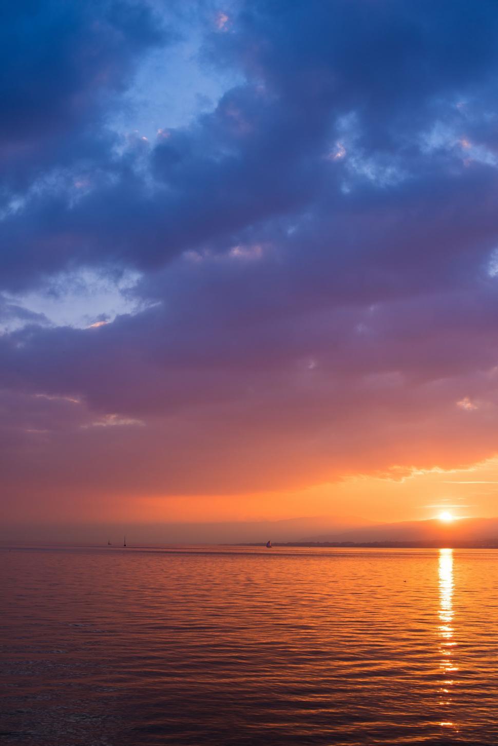 Free Image of Sun Setting Over Ocean With Boat 