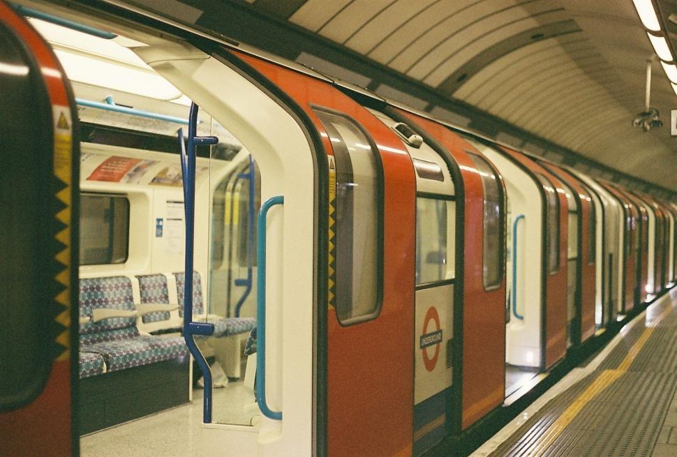 Free Image of Red and White Train Pulls Up to Platform 