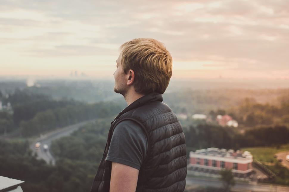 Free Image of Man Standing on Top of Tall Building 