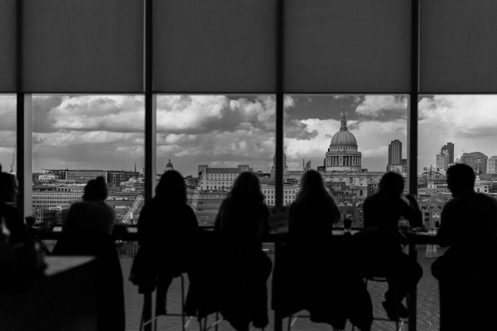 Free Image of Group of People Sitting at Table in Front of Window 