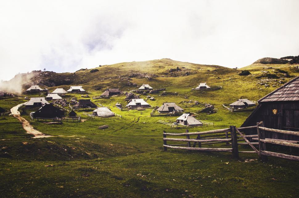 Free Image of Small Village on Hill With Fence 