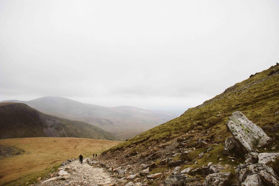 Free Image of Person Walking Up Hill on Foggy Day 