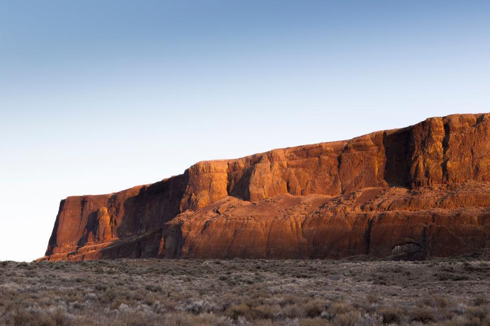 Free Image of Massive Rock Formation in Desert Landscape 
