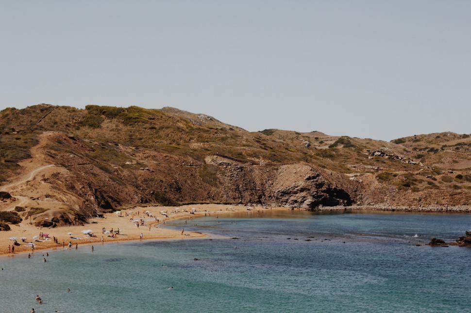 Free Image of Group of People Enjoying Beach by Waters Edge 