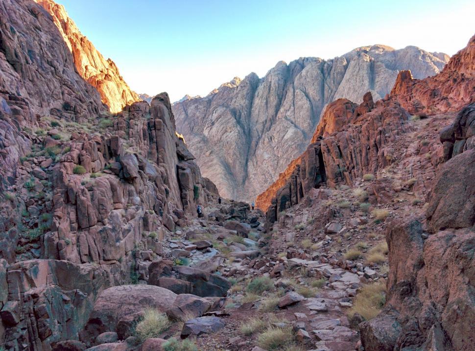 Free Image of Rocky Canyon With Mountain Range in Background 