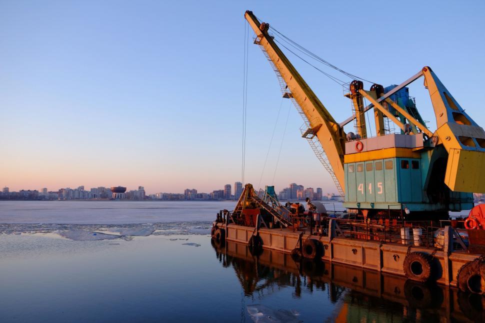 Free Image of Crane Perched on Body of Water 